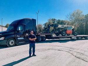 Flat Bed Truck hauling equipment